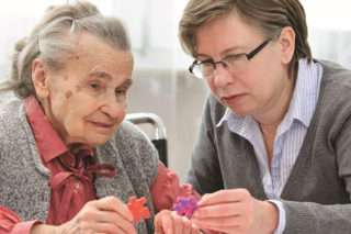 Staff Assisting Memory Care Patient